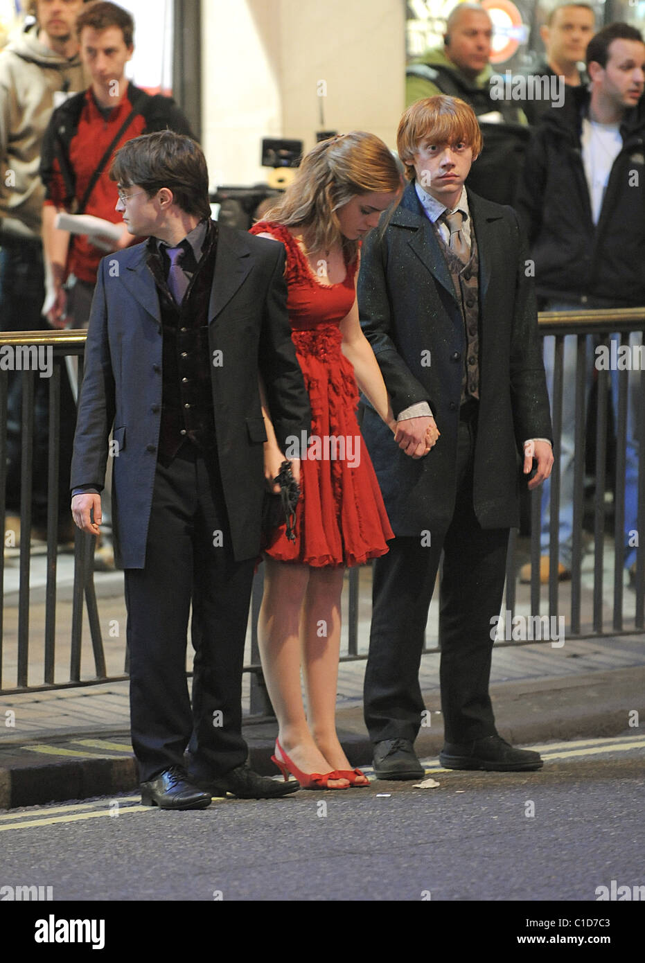 Daniel Radcliffe, Emma Watson and Rupert Grint bring the West End to a standstill as they film scenes for the last movie in the Stock Photo