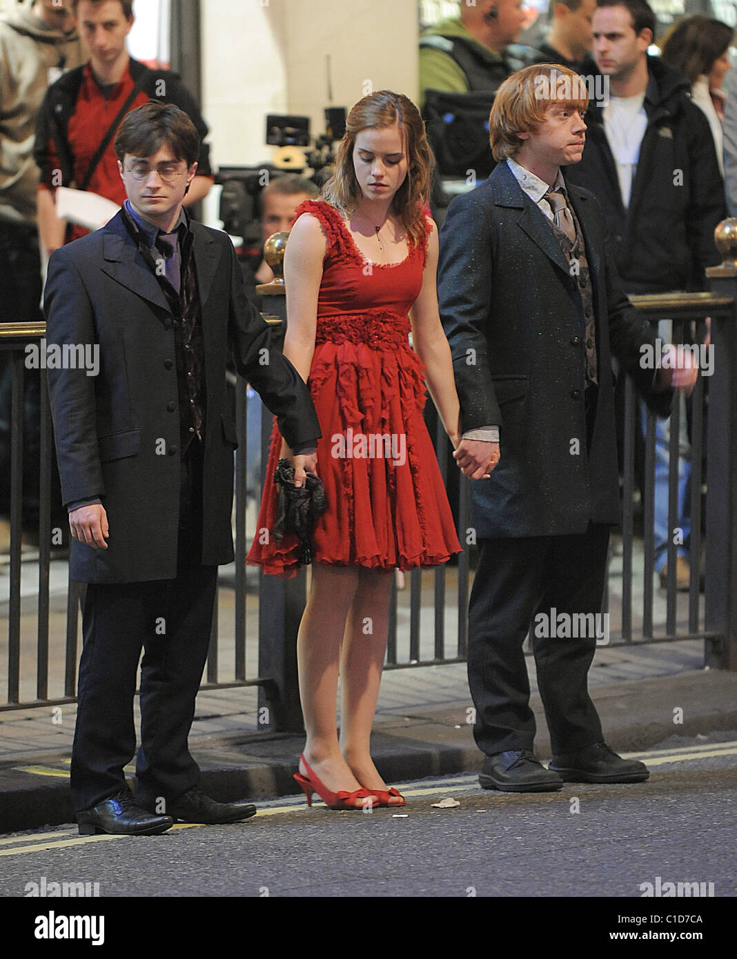 Daniel Radcliffe, Emma Watson and Rupert Grint bring the West End to a standstill as they film scenes for the last movie in the Stock Photo