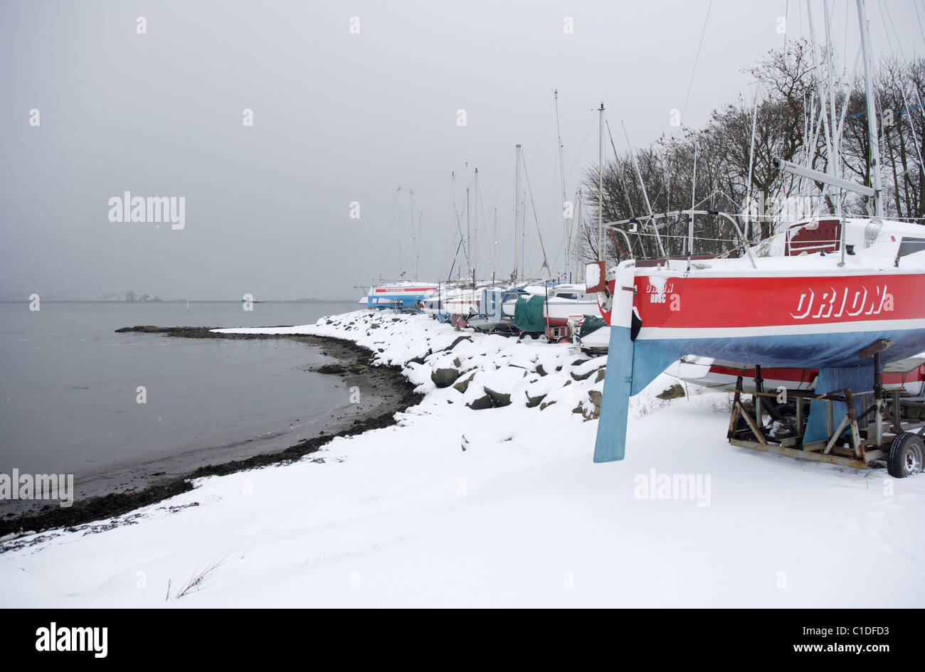 Boats at Dalgety Bay sailing club during a heavy snow fall Stock Photo