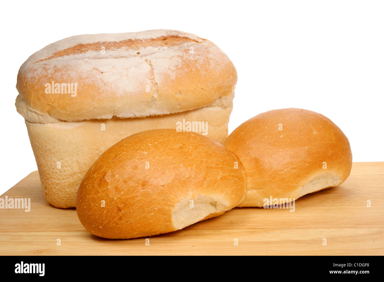 Bread loaf and rolls on wooden board Stock Photo