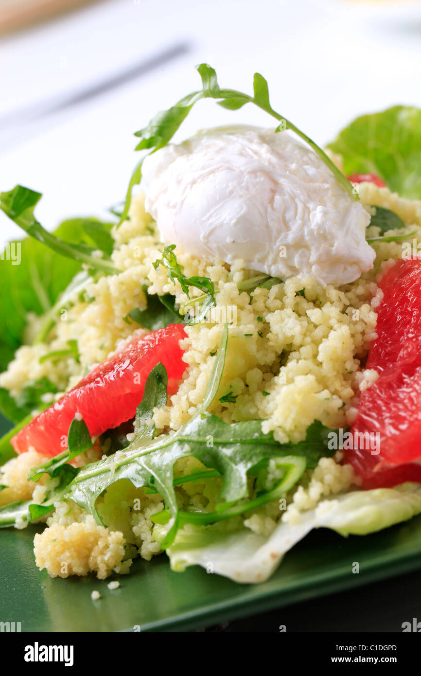 Couscous with red orange and rocket, poached egg on top Stock Photo Alamy