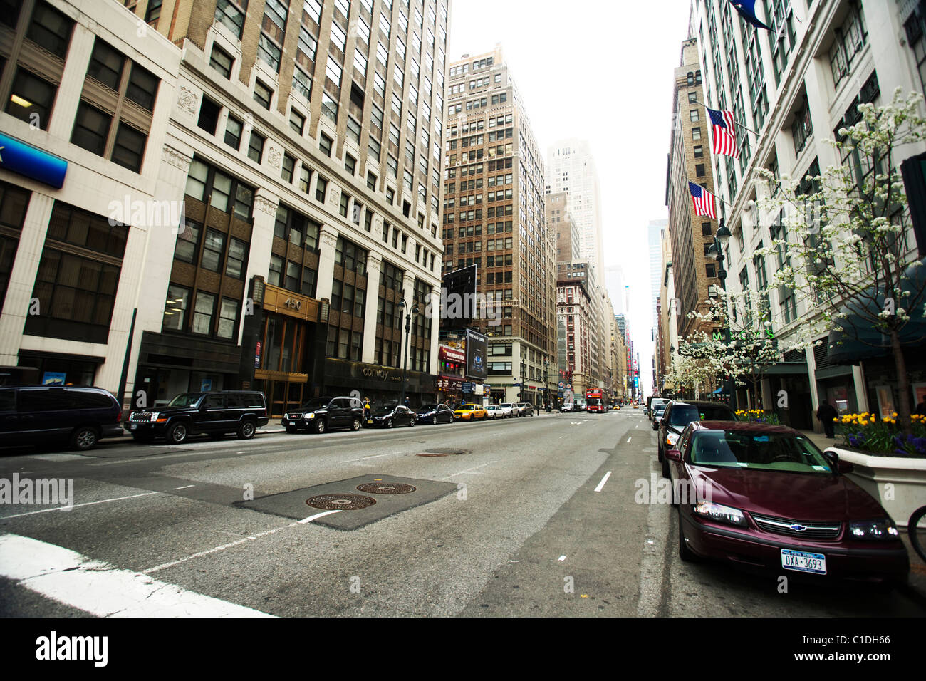 Cars parked on either side of a street in New York city Manhattan with ...
