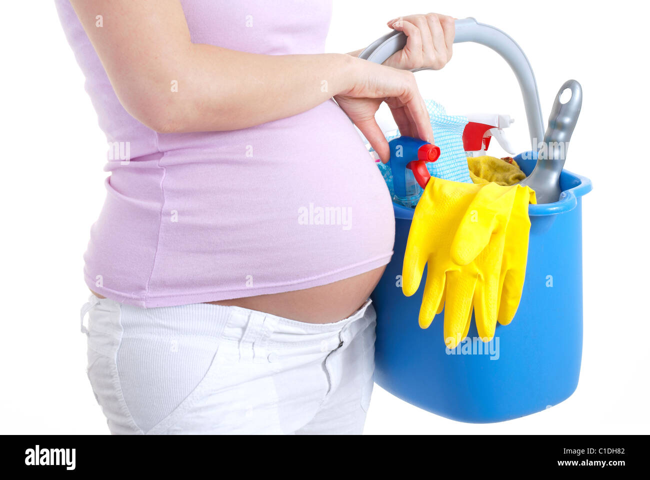 Pregnant woman holding cleaning products (nesting Stock Photo Alamy