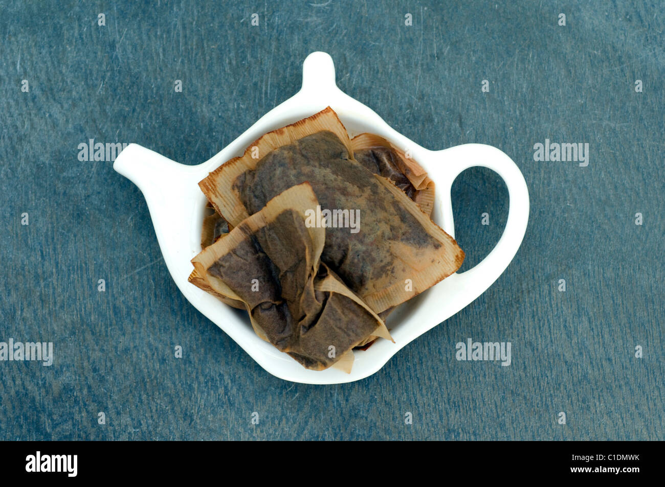 Used English Breakfast Tea Bags in a Teapot shaped drip recepticle. Stock Photo