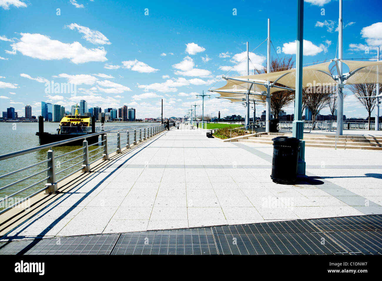 New York skyline under blue sky with a New York yellow water taxi Stock ...