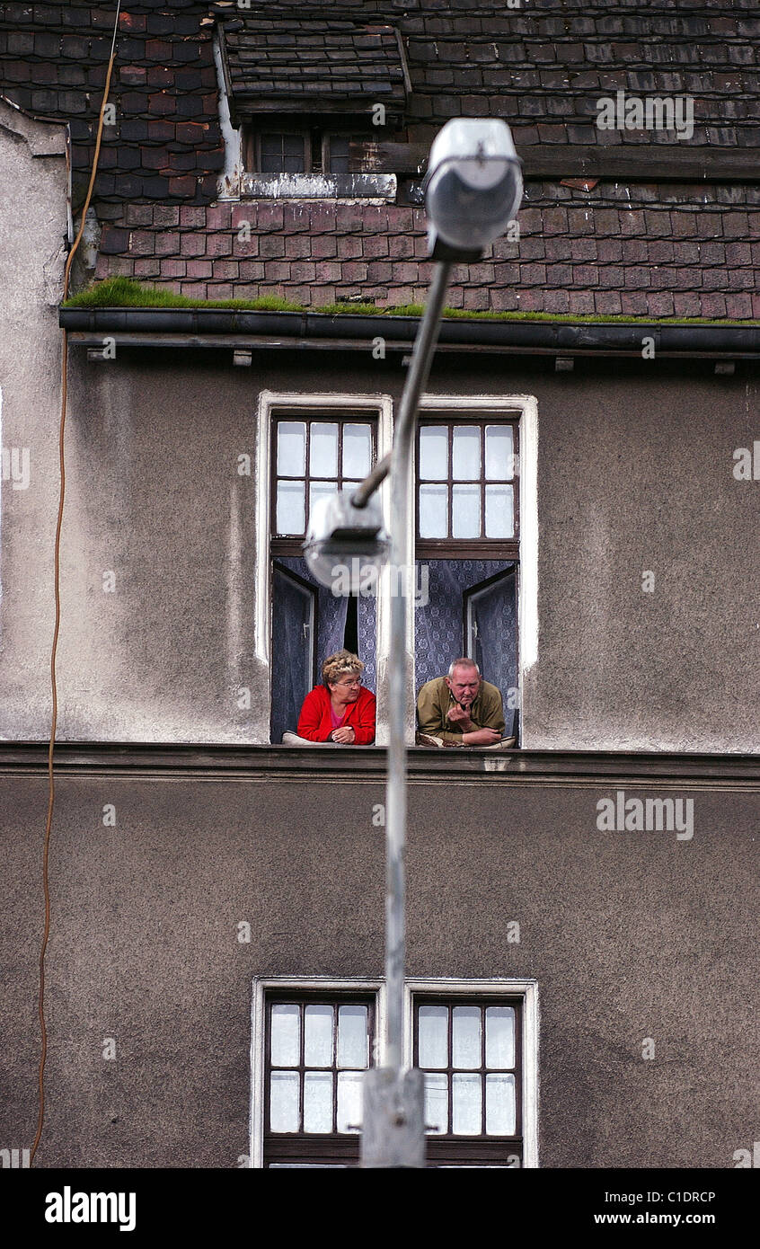 Poland, Eastern Pomerania, Gdansk, old couple at the window near the shipyard Stock Photo