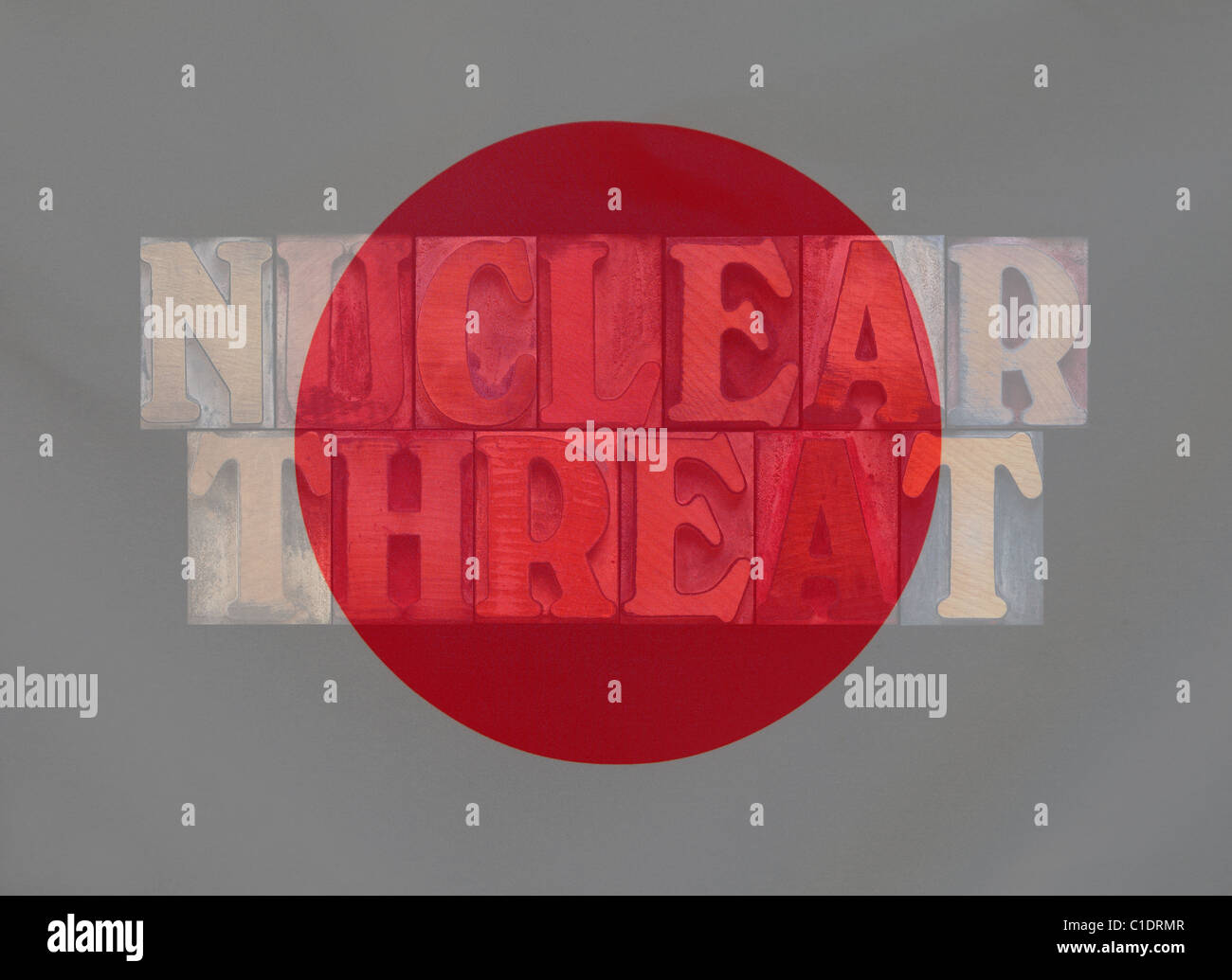 the words nuclear threat layered with the Japanese flag Stock Photo