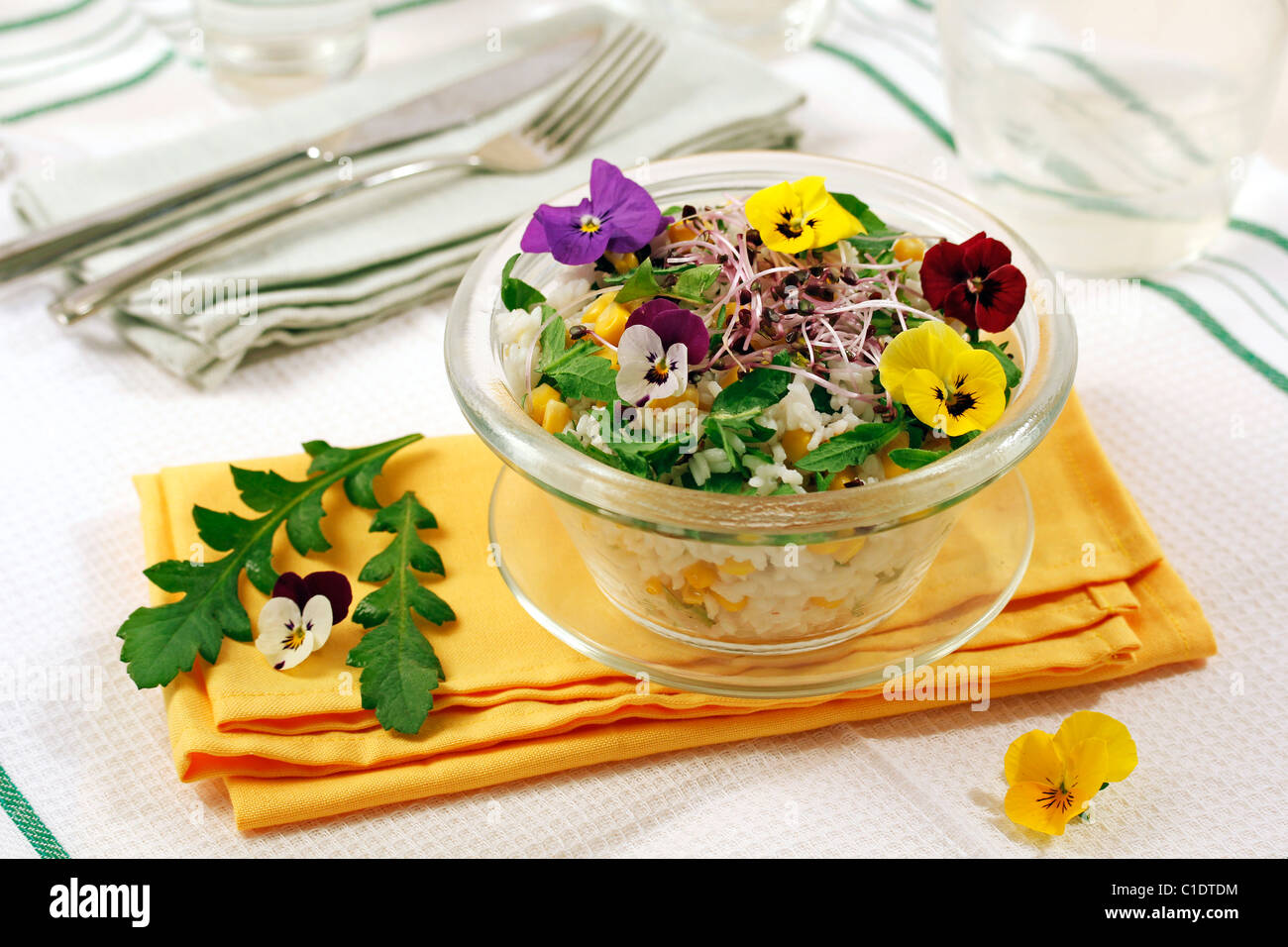Rice salad with pansies. Recipe available Stock Photo Alamy