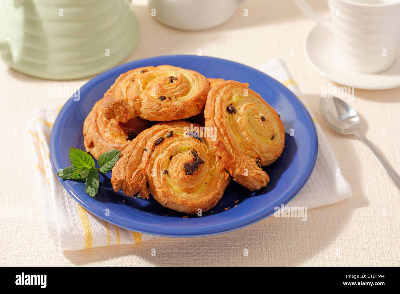 Mini schneckens with custard and raisins. Recipe available. Stock Photo