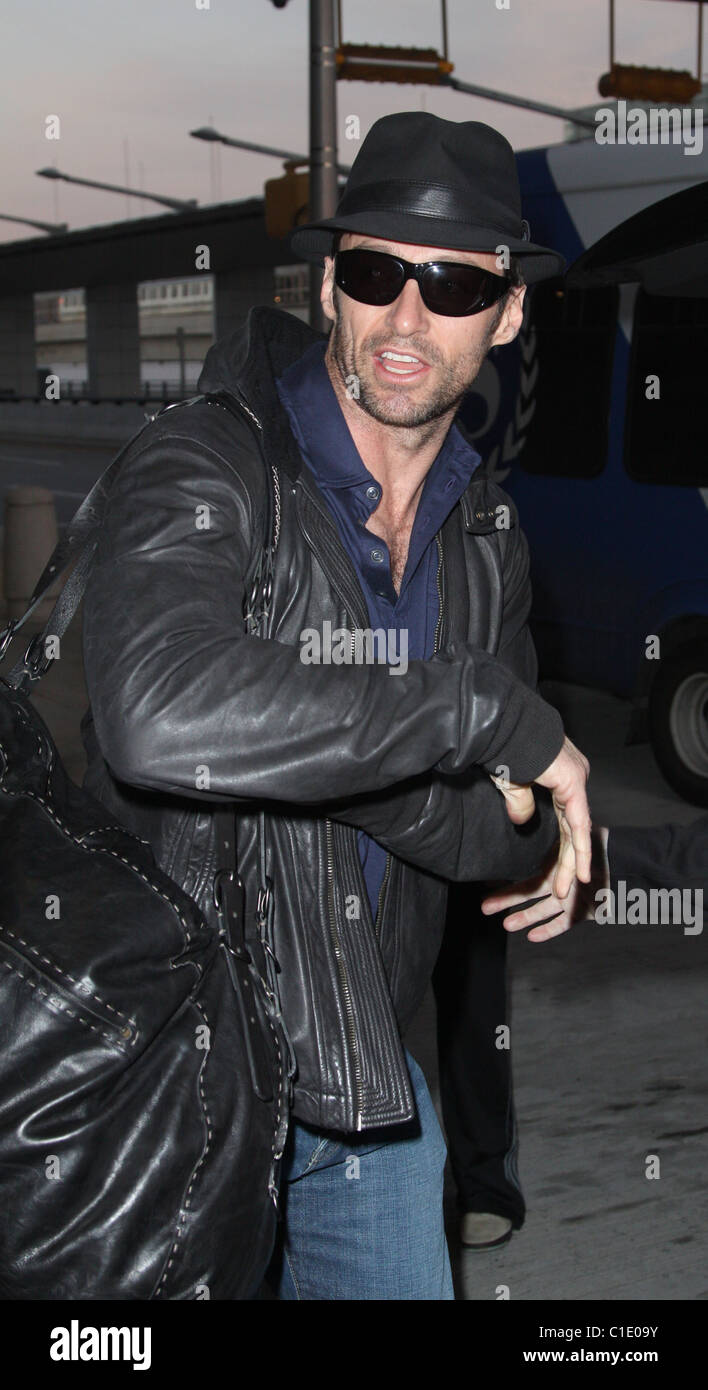 Hugh Jackman arriving back in New York City wearing a trilby hat after