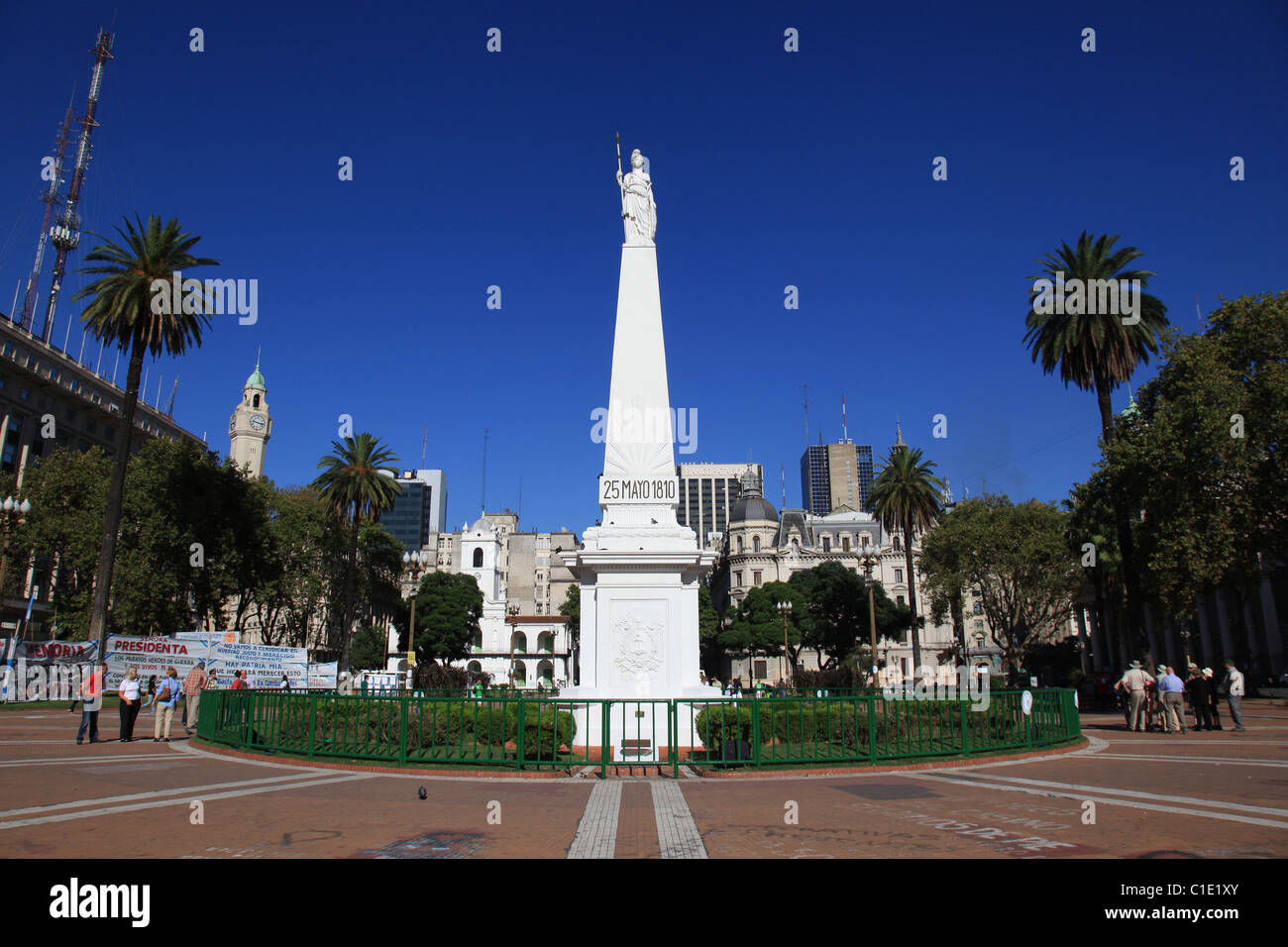 [Plaza de Mayo] [Buenos Aires] Argentina with white marble statue of the [May Pyramid] 1811 shining in sun and clear blue sky Stock Photo