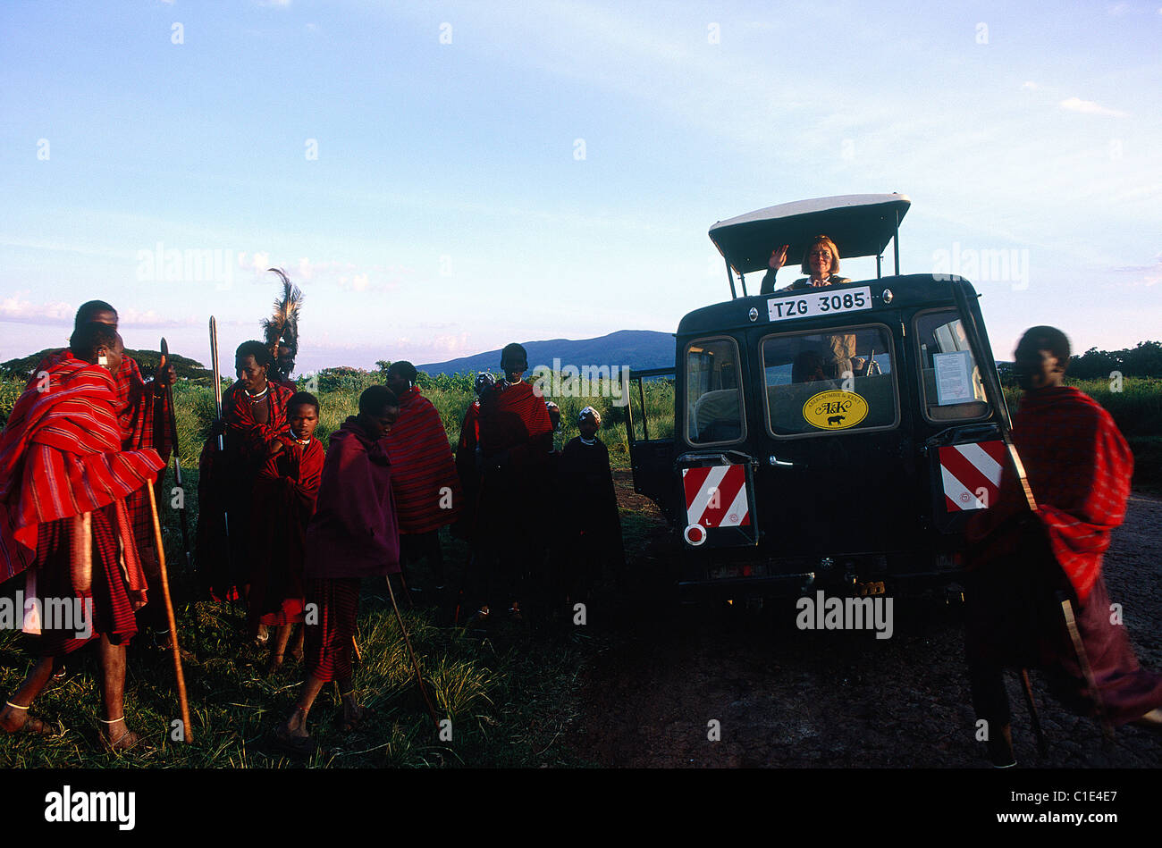 Tanzania, Serengeti National Park, Ngorongoro crater, tourists in four wheel drive cars greeted by Masai Stock Photo