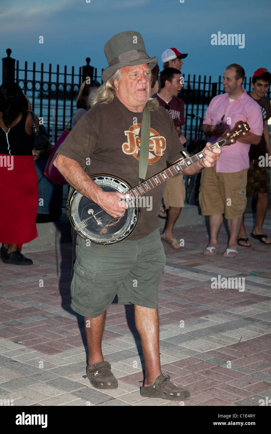 Busker banjo player and dog trainer at Mallory Square, Key West