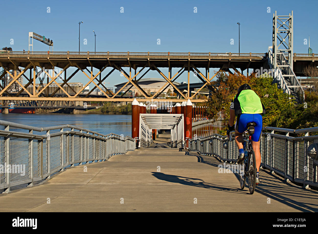 Unidentifiable Generic Cyclist Riding Bicycle along Willamette River Portland Oregon Stock Photo