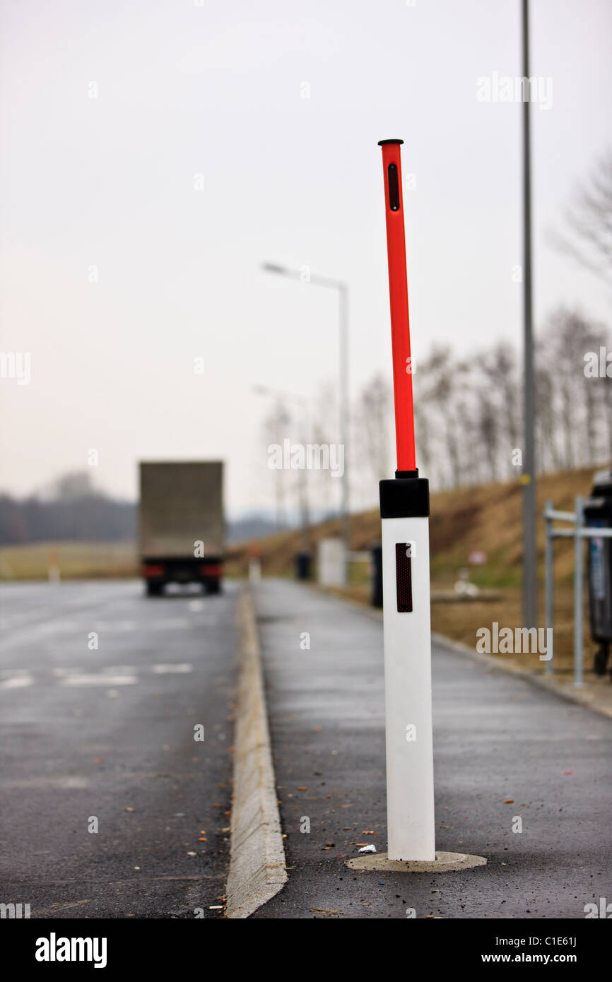 Road safety pole with extensible snow level marker at motorway parking in Austria Stock Photo