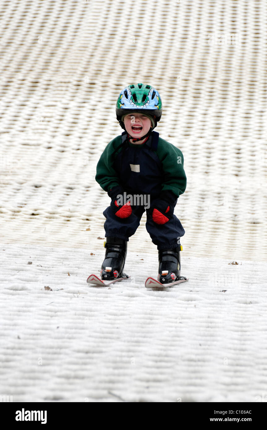 A young boy learning to ski on a dry ski slope Stock Photo