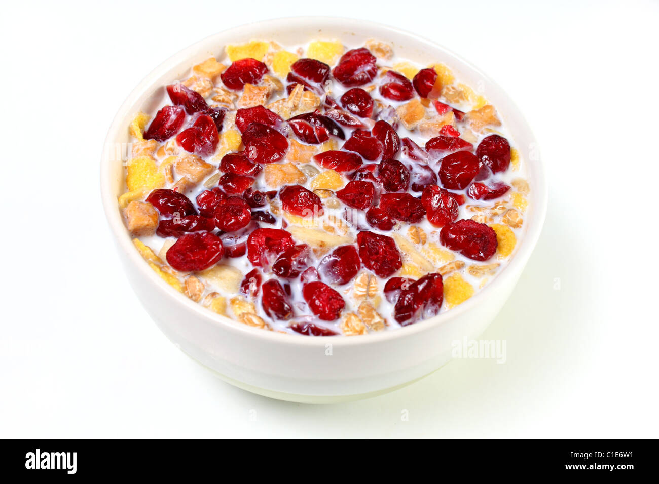 Bowl of muesli in hot milk with cranberries added on top Stock Photo