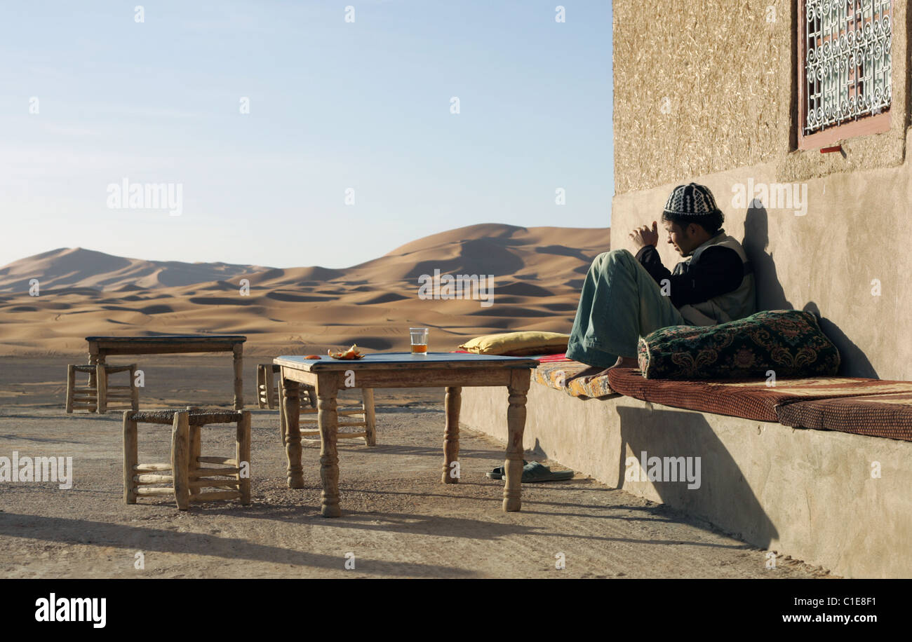 Berber Arab drinking tea, Erg Chebbi, Morocco. Stock Photo