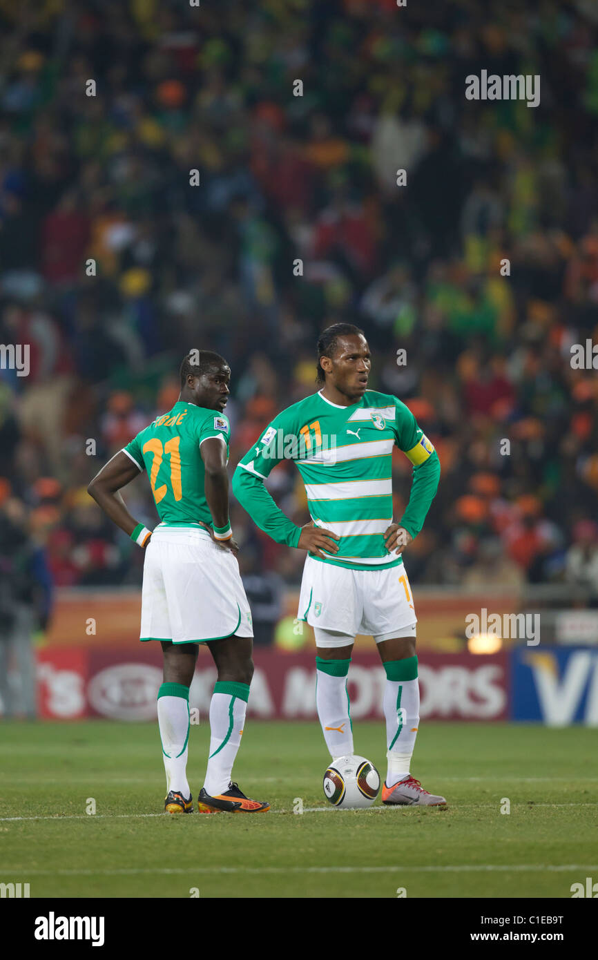 Cote d'Ivoire players Emmanuel Eboue (21) and Didier Drogba (11) wait to kick off the ball after conceding a goal to Brazil. Stock Photo