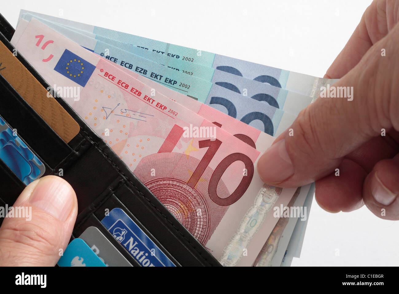 Hand taking euros out of wallet. Stock Photo