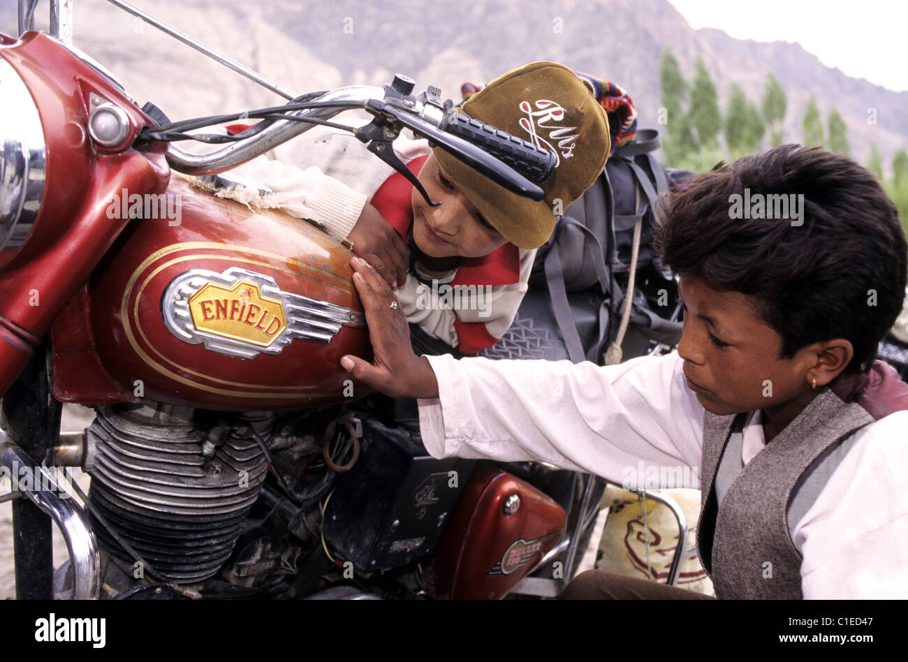 India, Ladakh, kids fascinated by an Enfield indian bike Stock Photo ...