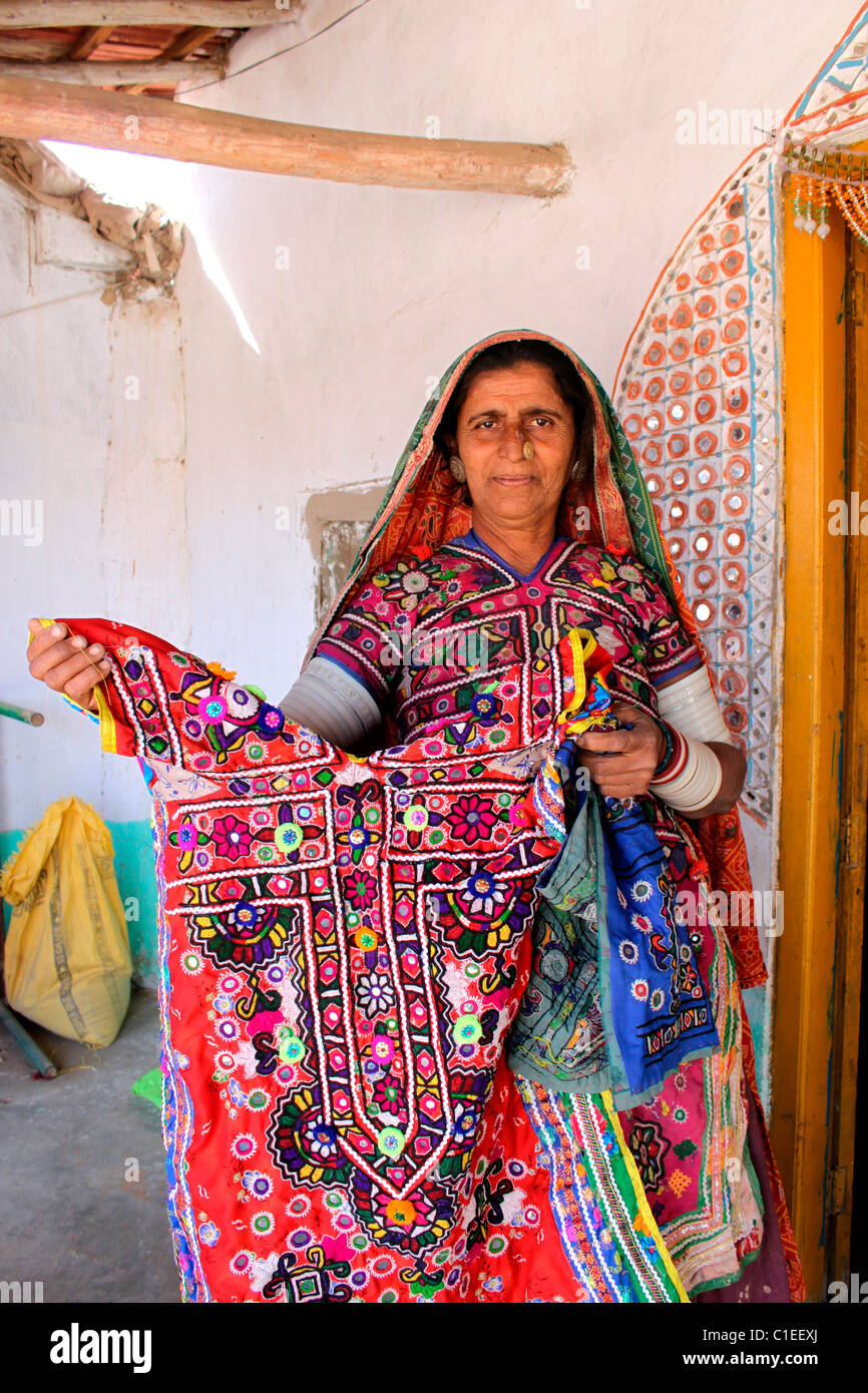 A woman in Kutch, Gujarat, showing her finished work on clothe Stock Photo