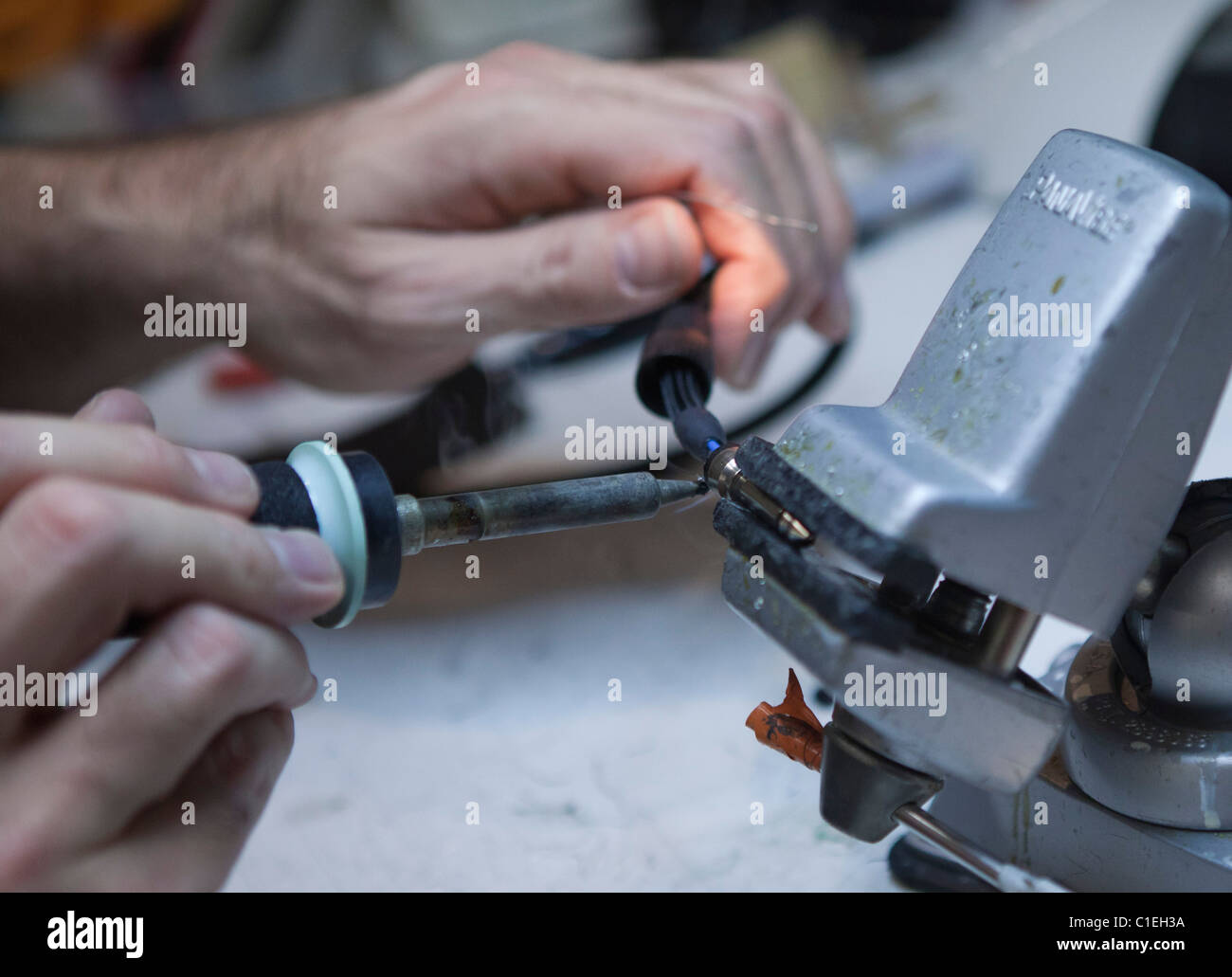 Soldering a quarter inch connector onto a guitar cable Stock Photo Alamy