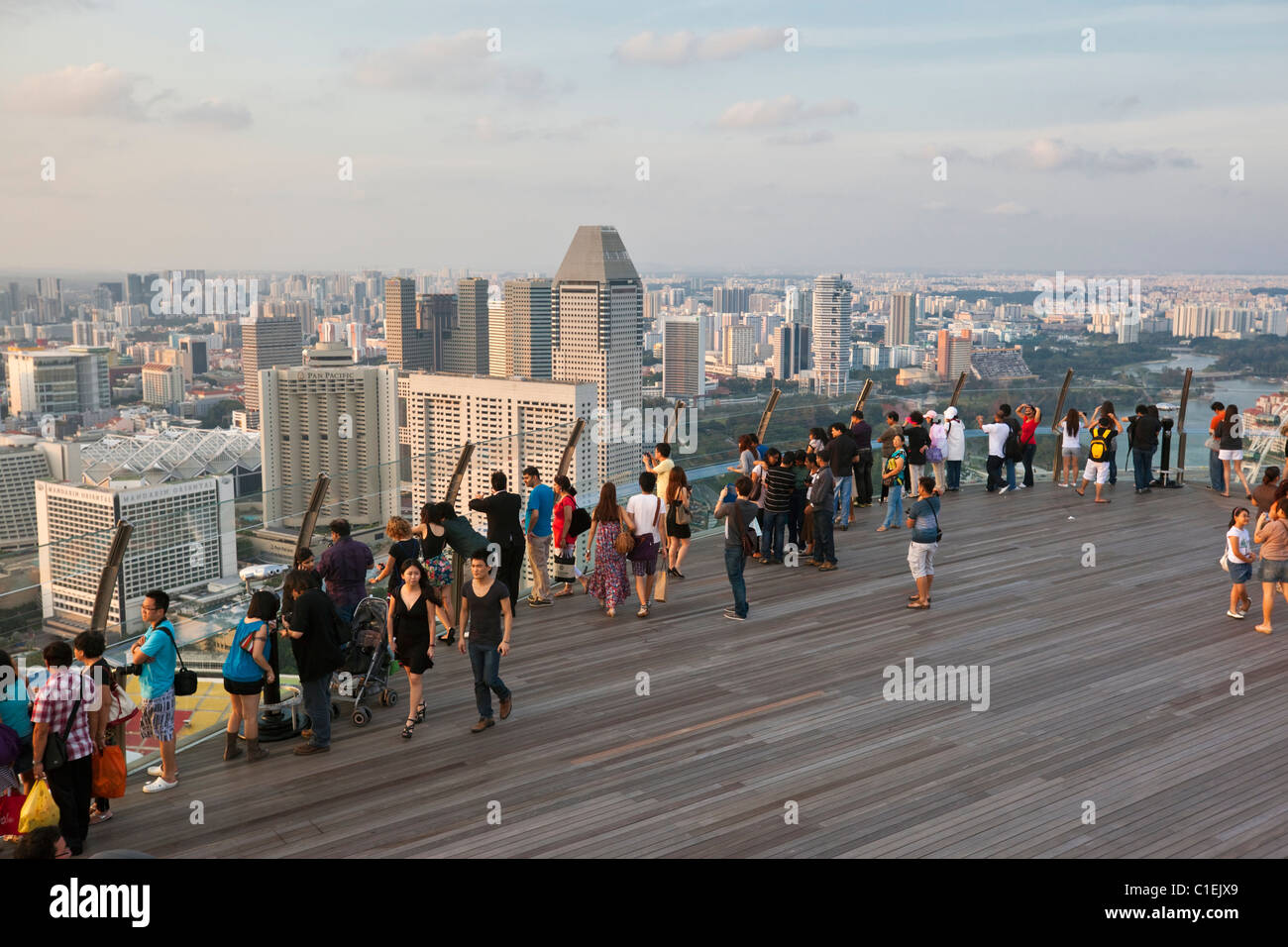 Visitors look out over Singapore skyline from observation deck of the Marina Bay Sands SkyPark.  Marina Bay, Singapore Stock Photo