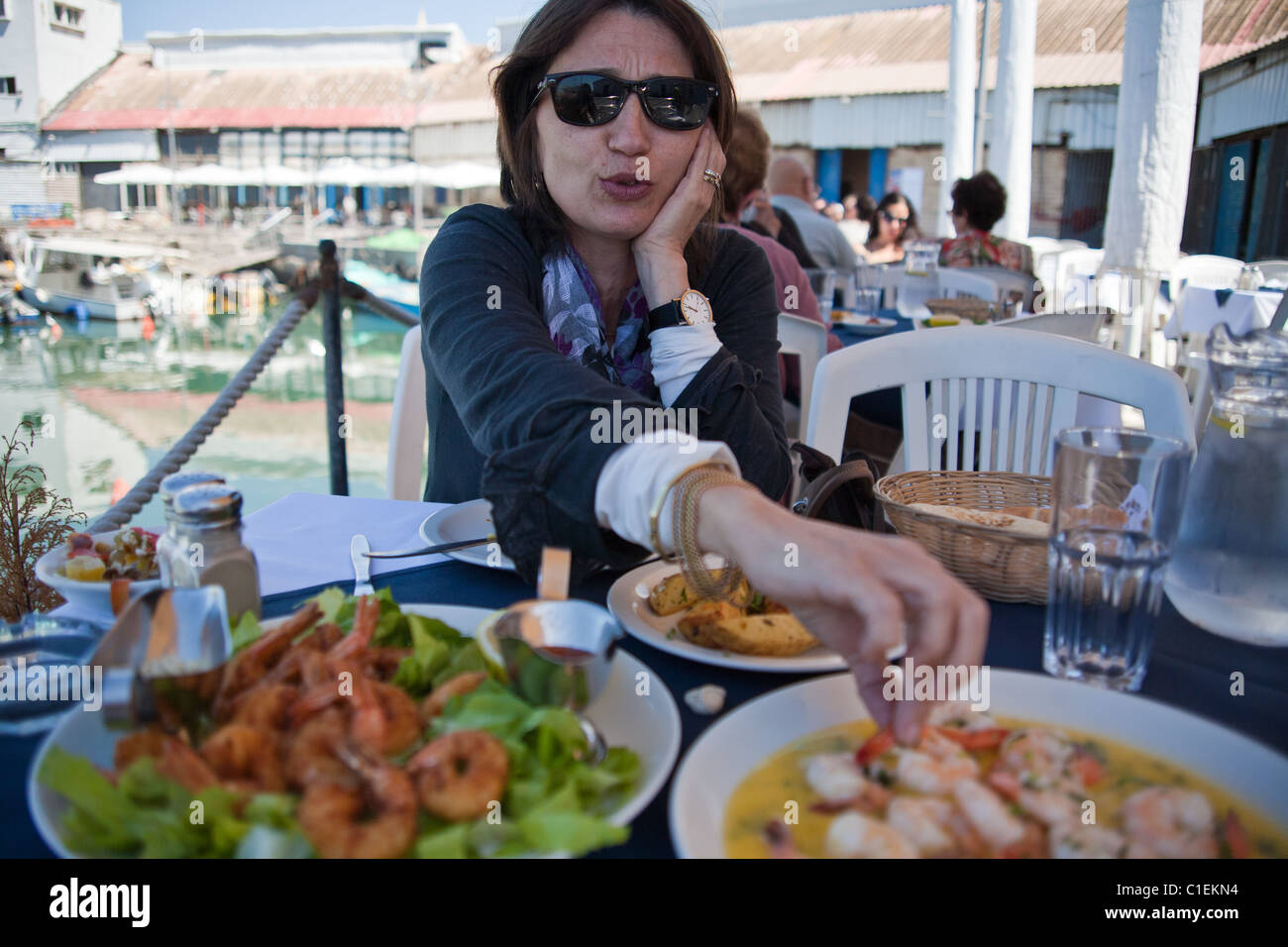 Woman eating shrimps Stock Photo