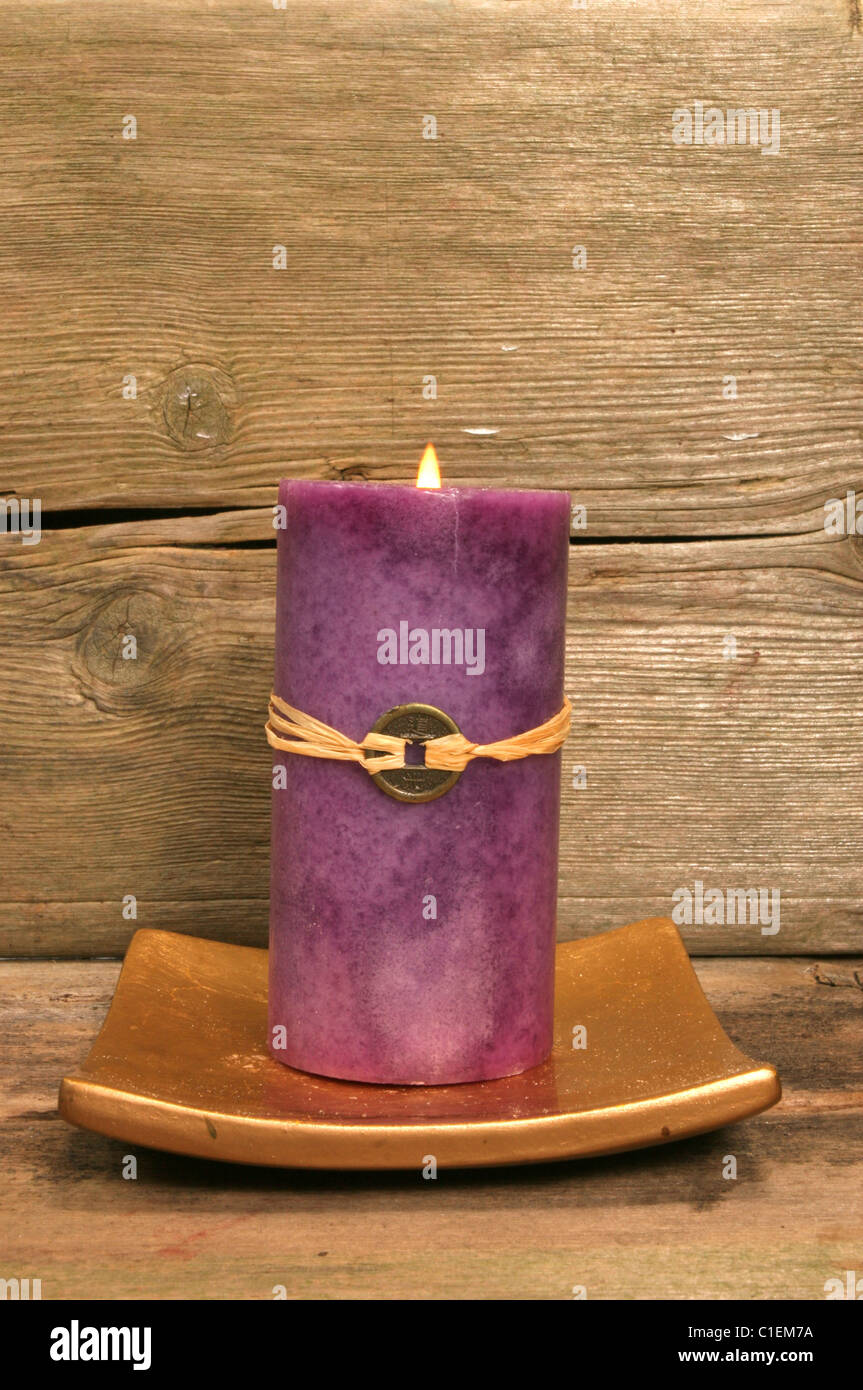 Purple Feng Shui candle against wood Stock Photo Alamy