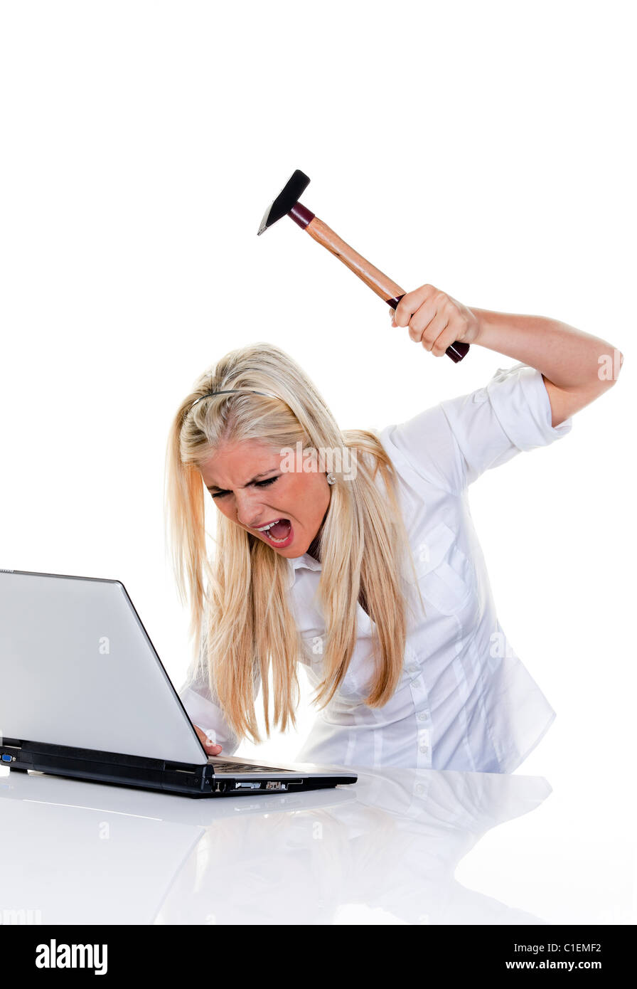 woman has problems with computer; hammer and laptop Stock Photo