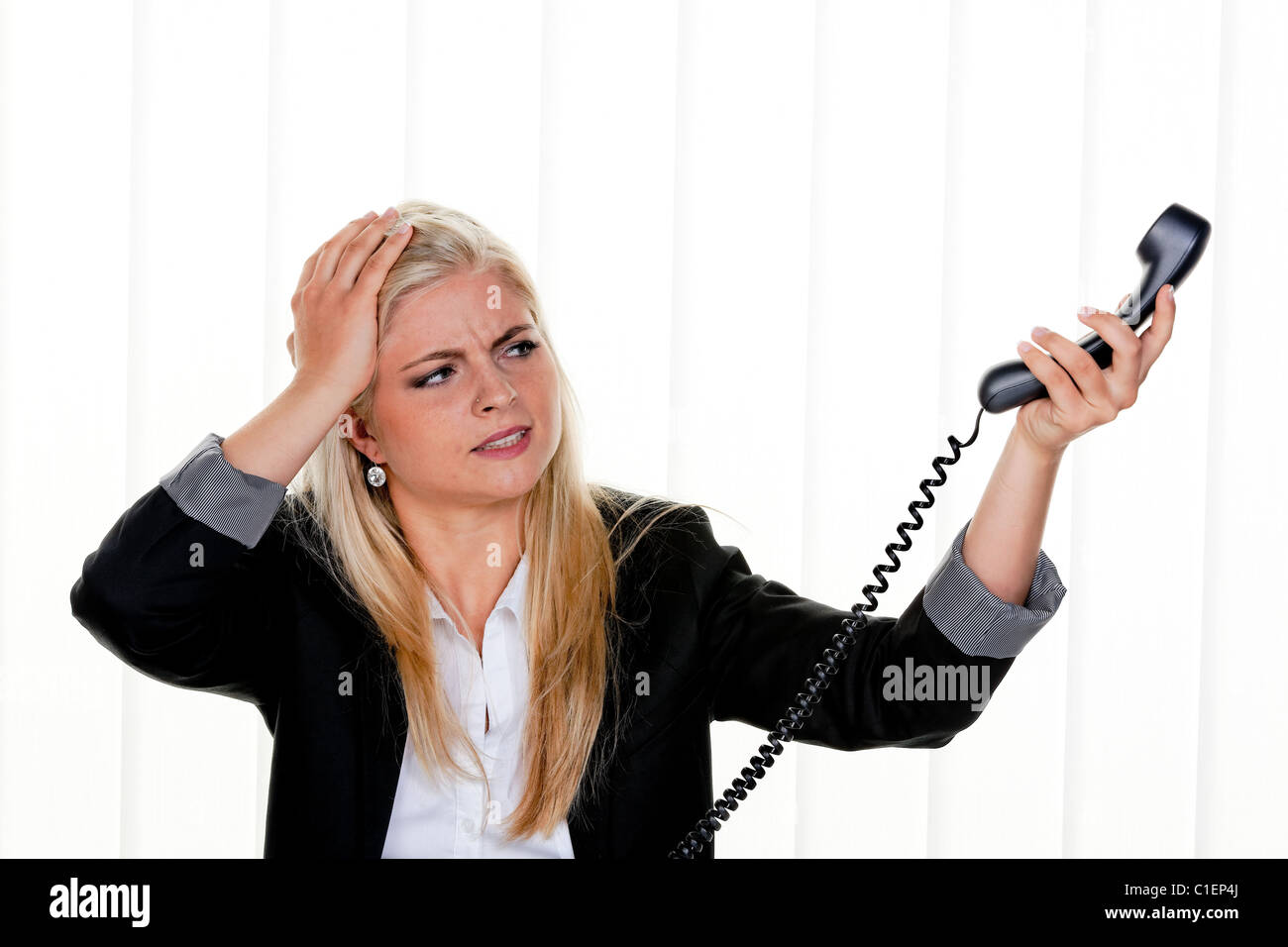 Young woman with problems and stress in the office Stock Photo