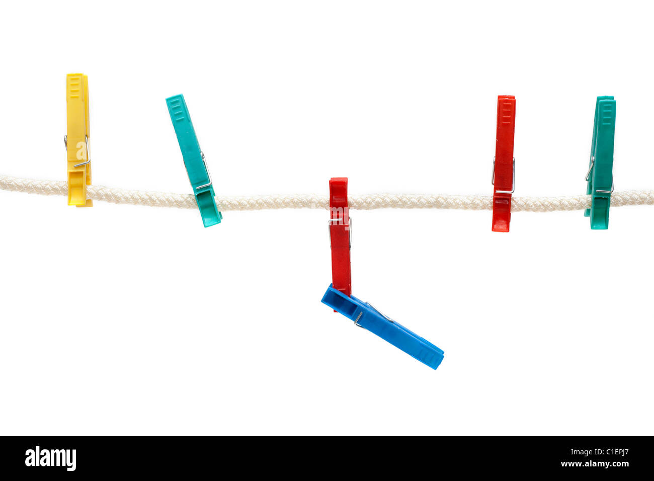 Colour clothes-pegs hung on linen rope, insulated on white background Stock Photo