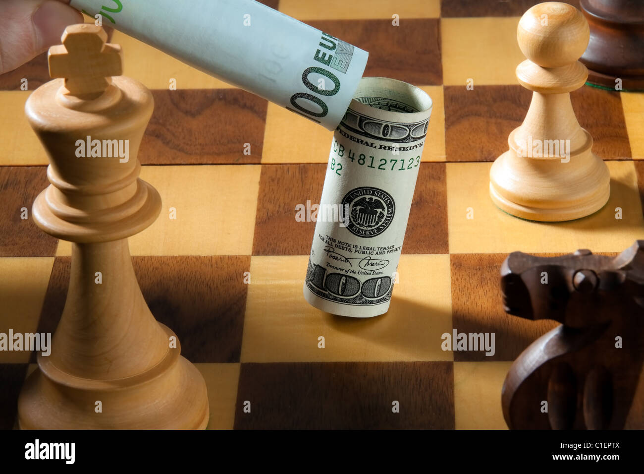 Chess with dollar and euro bank note. Icon for devaluation of the dollar against euro. Stock Photo