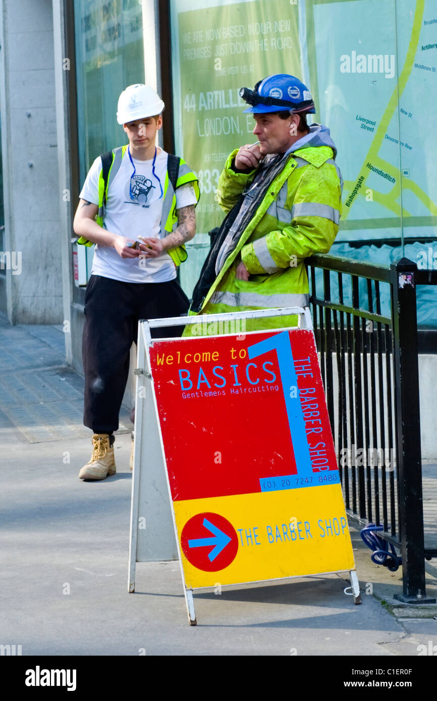 City of London , British Workers , workmen in safety jackets enjoy roll