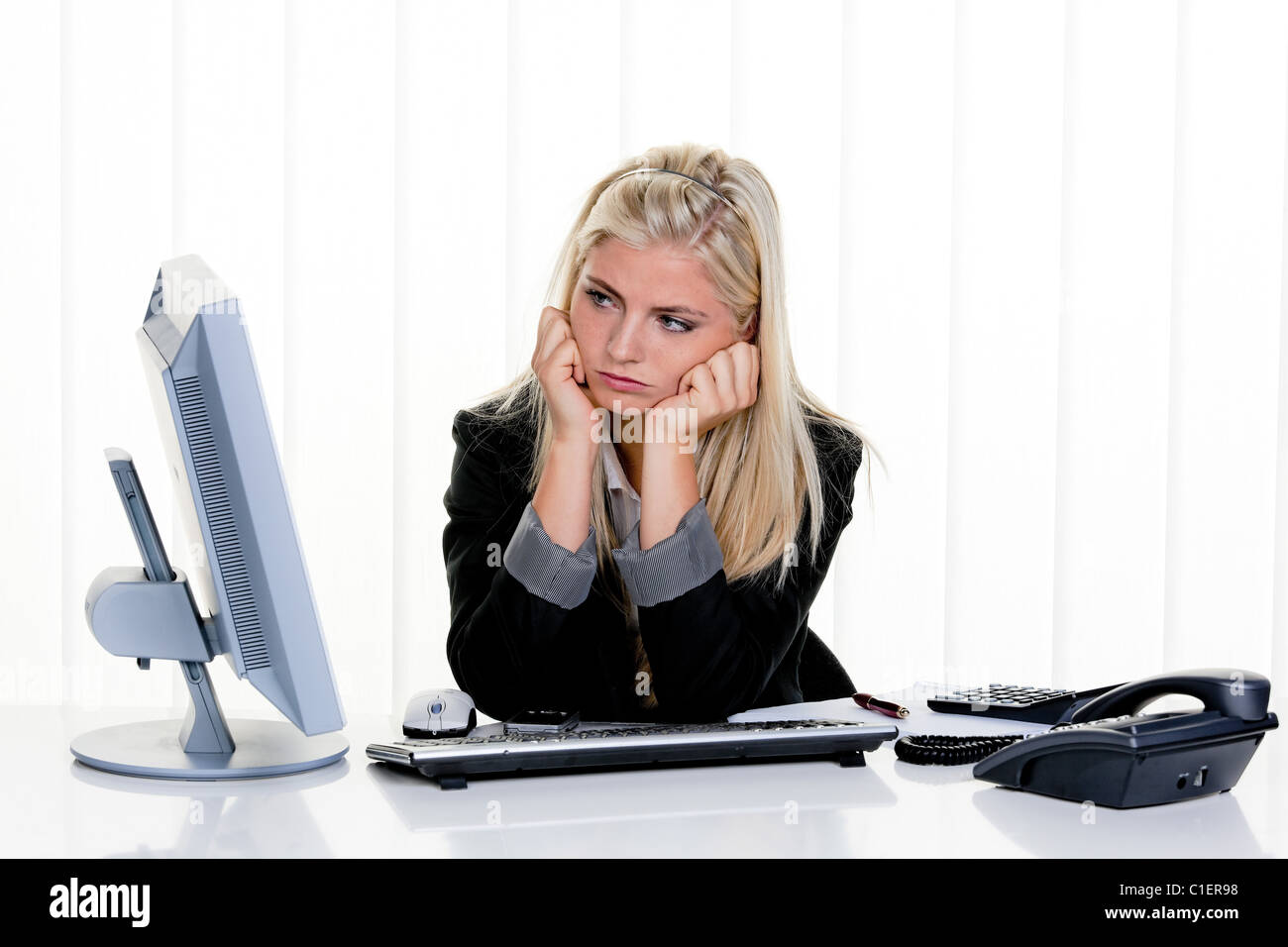 young stressed woman with problems in office Stock Photo