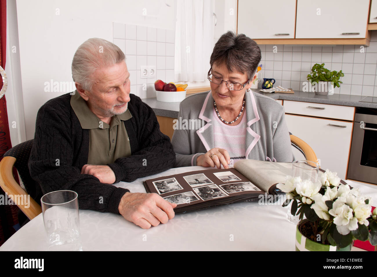 Happy senior couple looking at a photo album. Stock Photo