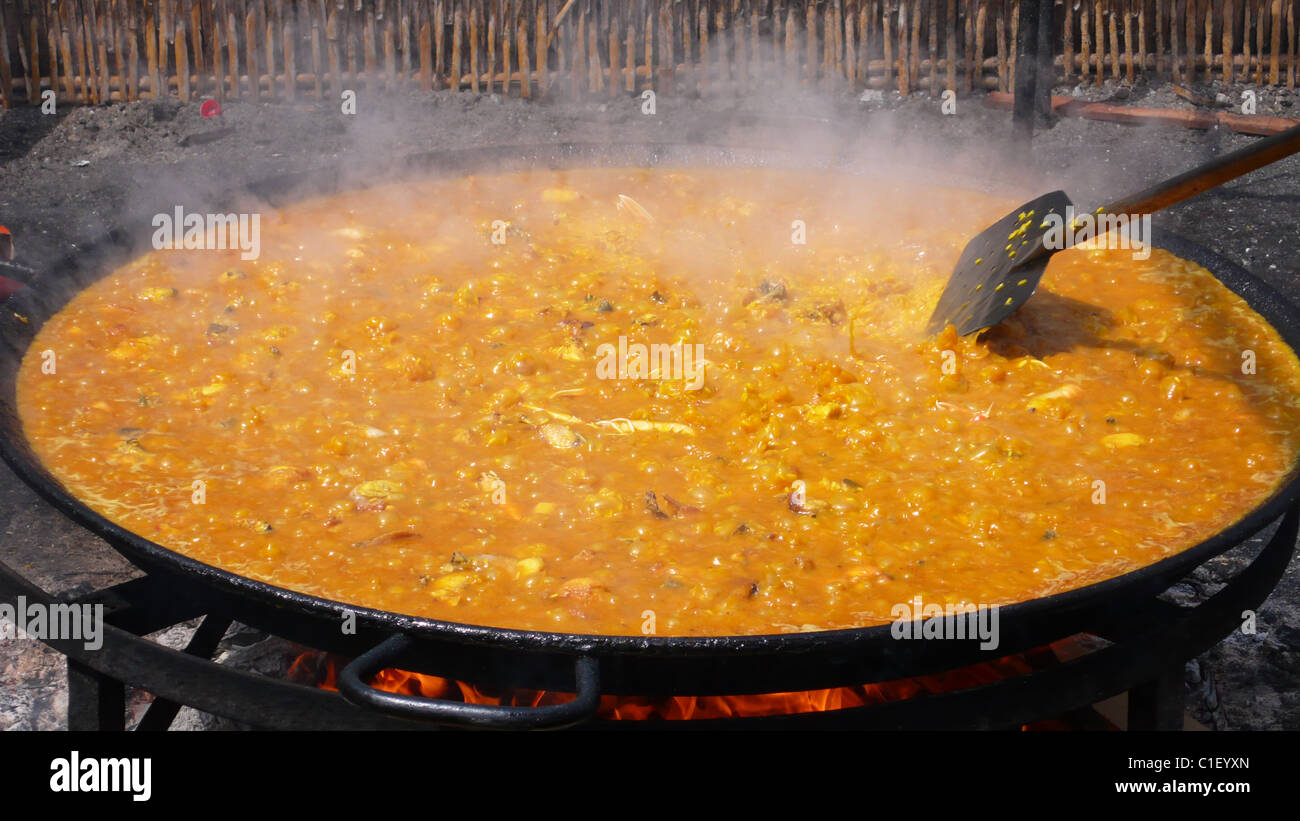 Big paella being cooked in an outdoor restaurant in Spain Stock Photo