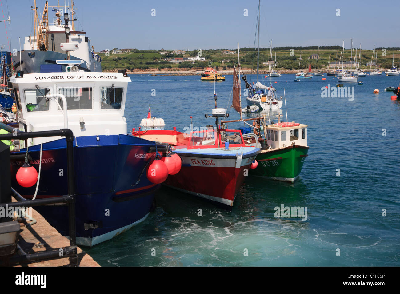 Pleasure boats and fishing boat side by side at the Quay in St.Mary's Isles of Scilly Stock Photo