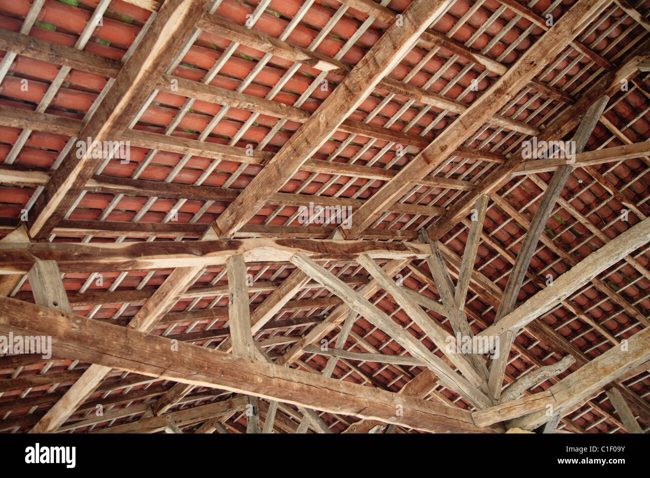 Beams and rafters on the underside of the roof of the covered market at Villefranche-du-Perigord, France Stock Photo