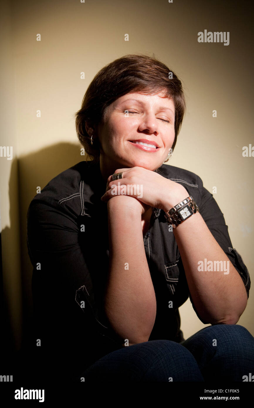 Portrait of a pretty young woman smiling with eyes closed Stock Photo ...