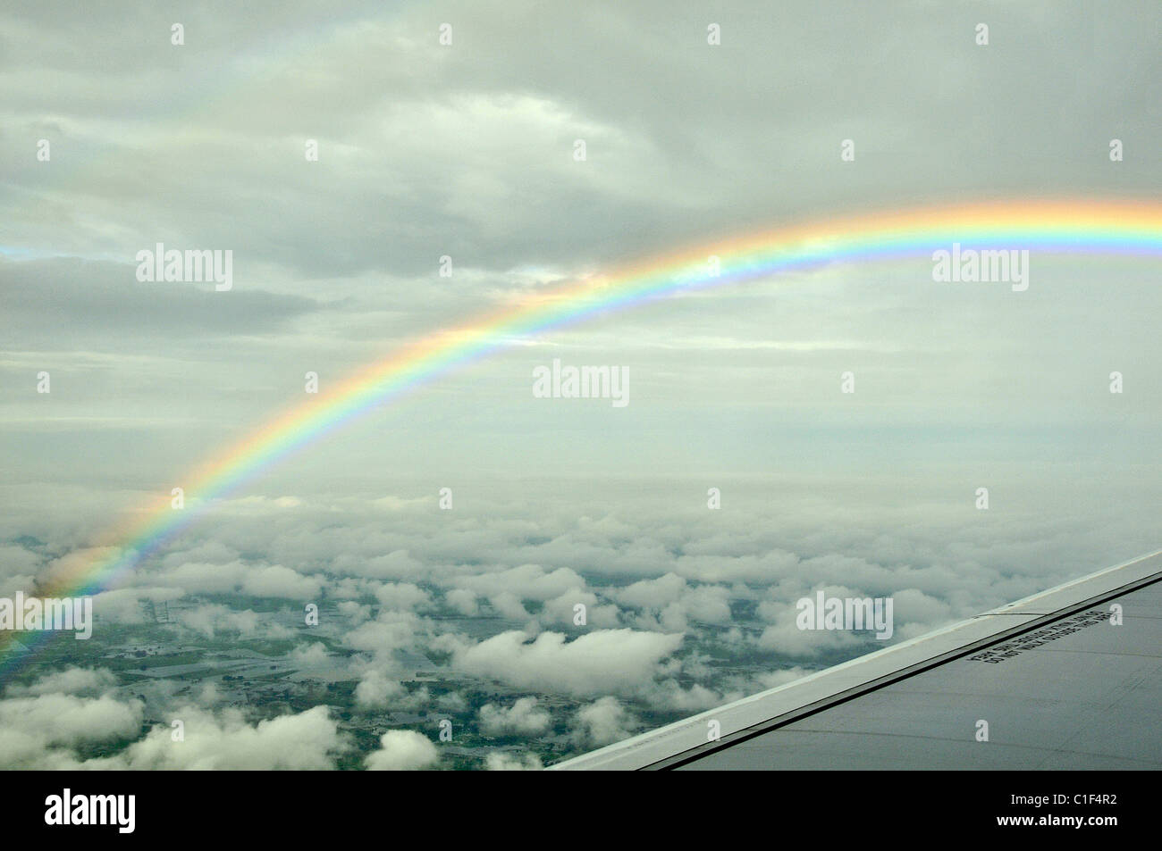 wing of airplane and rainbow Stock Photo - Alamy