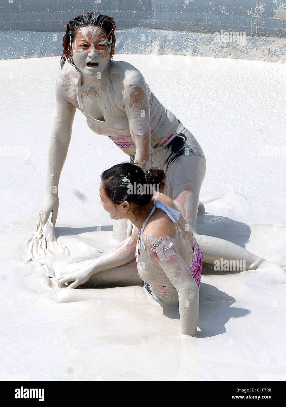 World Mud-Wrestling Championships Two filthy females grapple in a pit during an international women's mud-wrestling event in Stock Photo