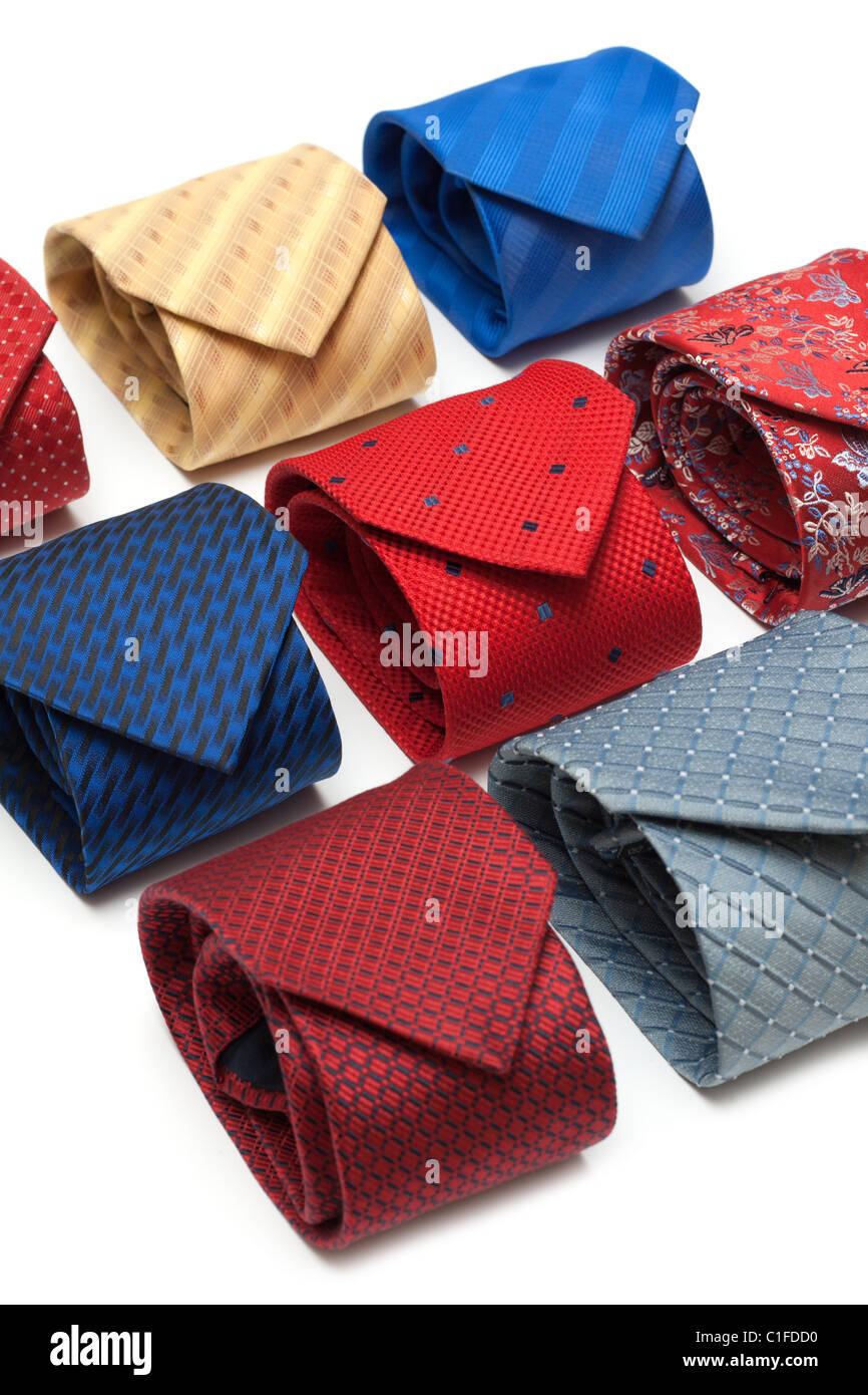 Varicoloured male ties convolute on white background Stock Photo - Alamy