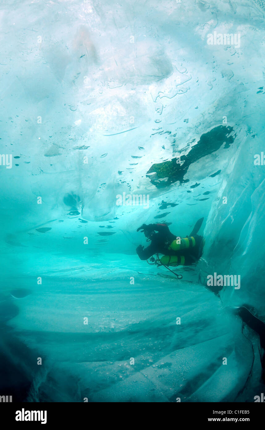 Scuba diver with sidemount under ice, in lake Baikal, Siberia, Russia, island Olkhon Stock Photo