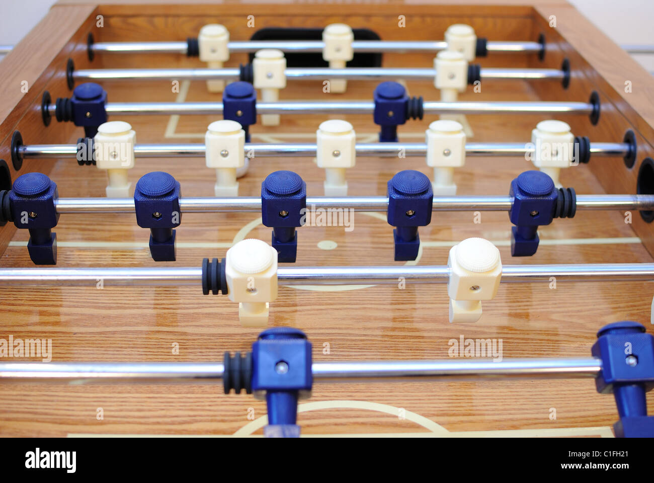 Foosball table in a carpeted room Stock Photo