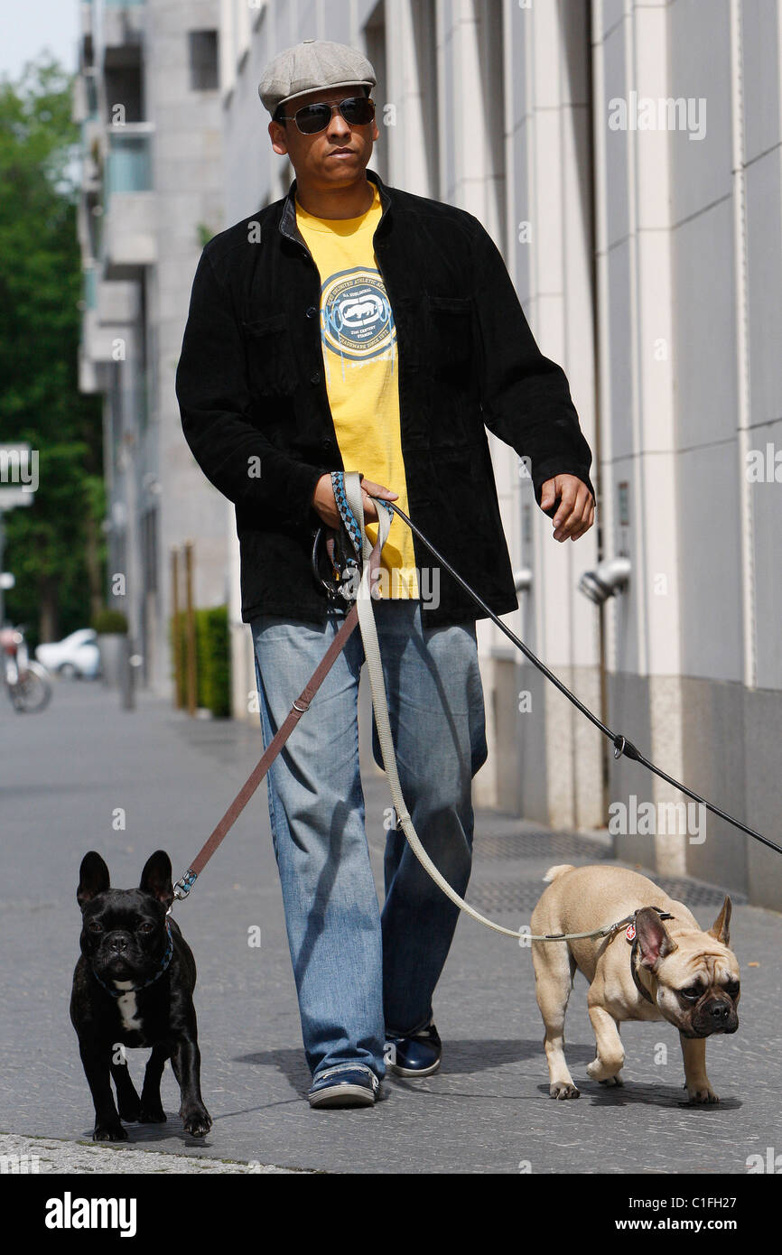 German singer Xavier Naidoo walks his dogs at Potsdamer Platz