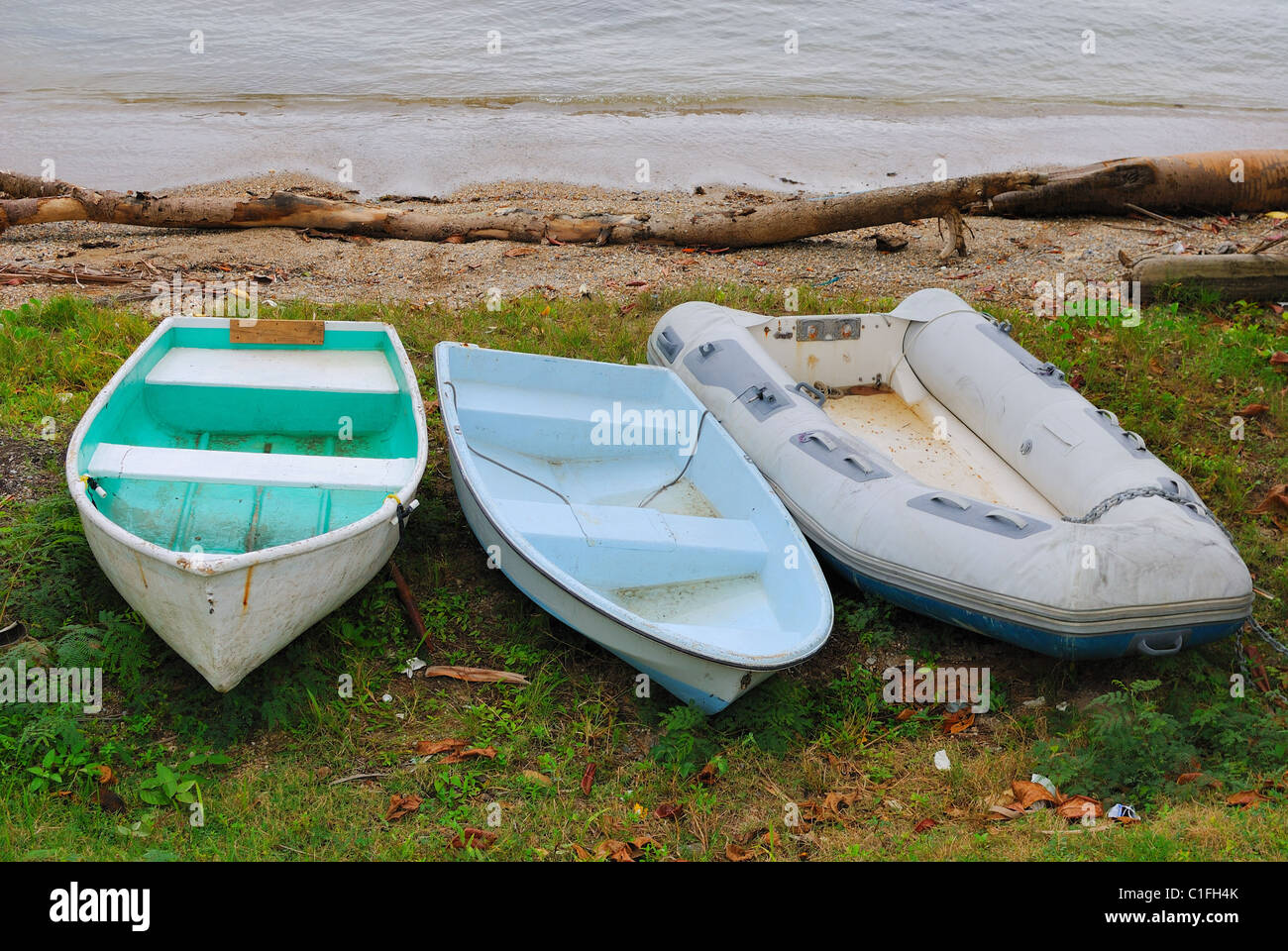 three dingy boats on shore Stock Photo