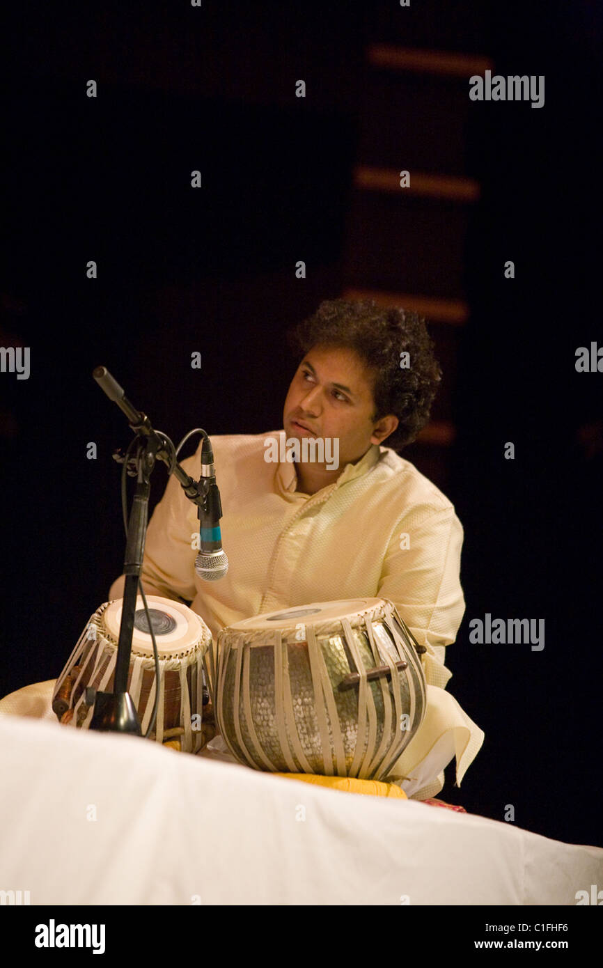Classical Indian musicians perform onstage including famous sarod