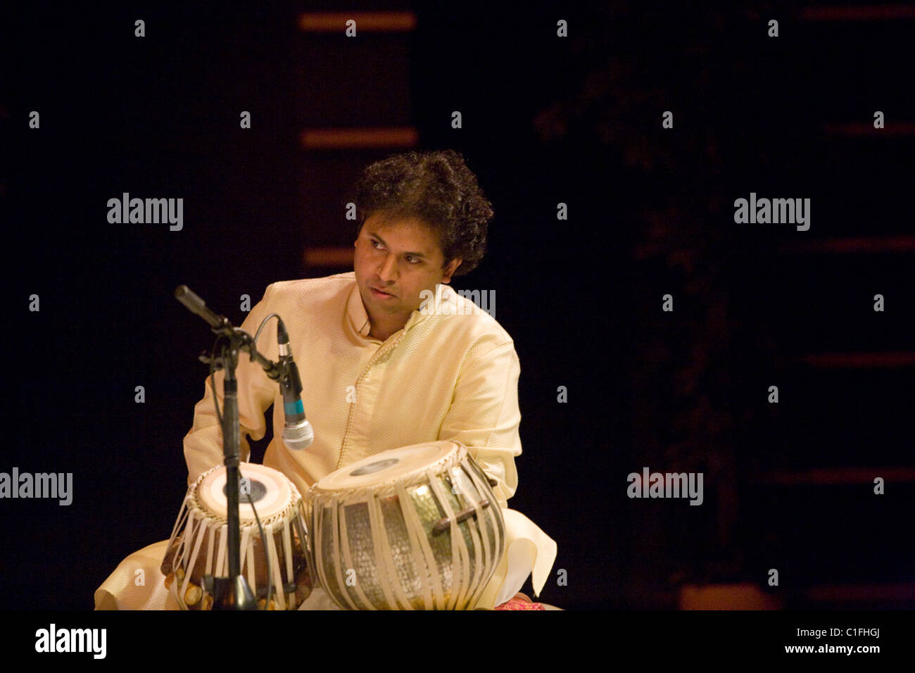 Classical Indian musicians perform onstage including famous sarod